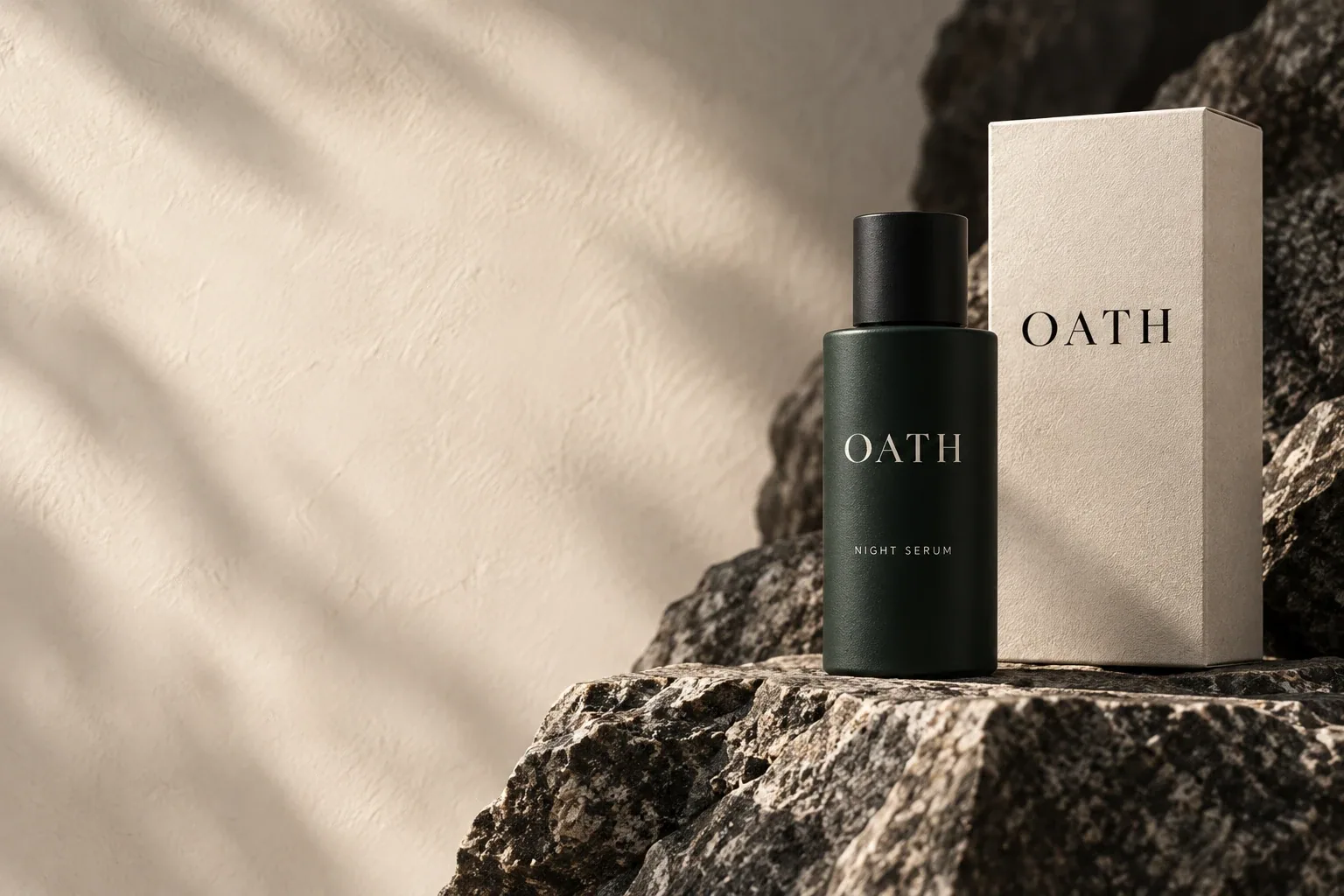 OATH Night Serum and cream carton on rugged coastal granite